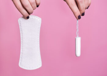 Women holding a sanitary napkin and tampon