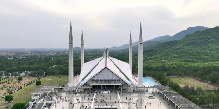 Aerial Drone Sunset Scene of Shah Faisal Mosque is one of the largest Mosques in the World which is situated in Islamabad, Pakistan.